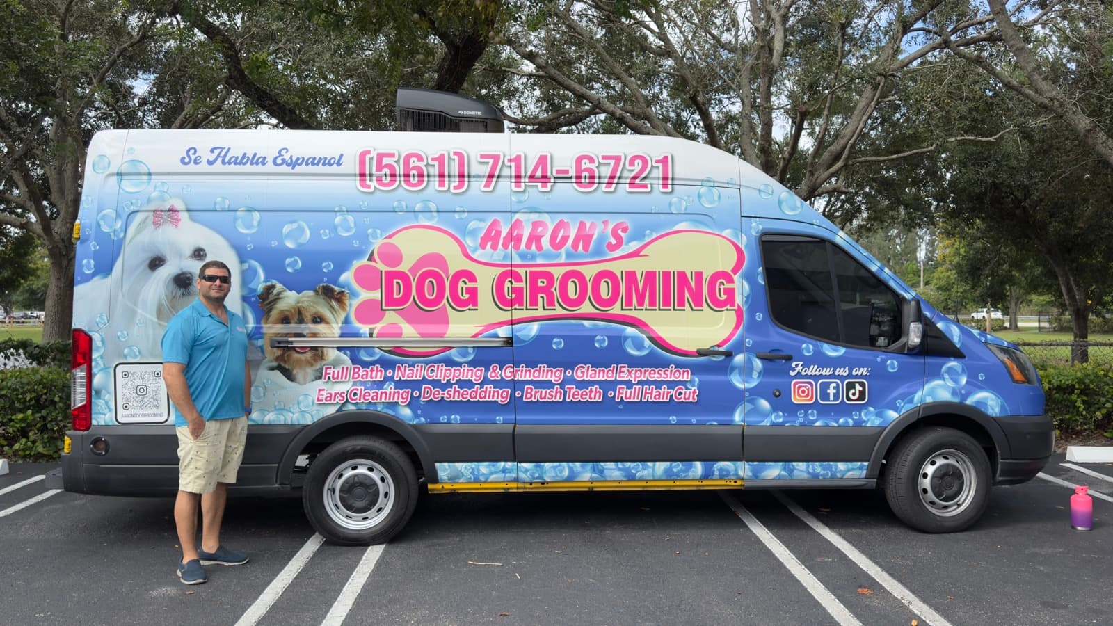 Aaron standing next to the grooming van